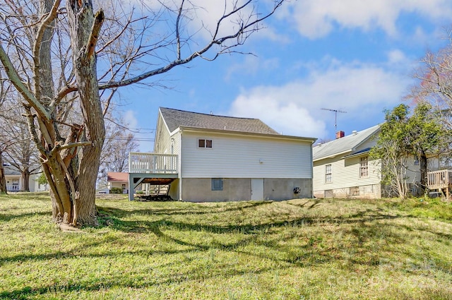 back of property with a yard and a deck