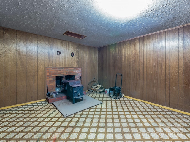 interior space with wooden walls, baseboards, and a textured ceiling