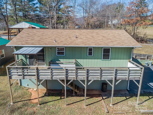 back of property featuring stairs, a deck, and roof with shingles