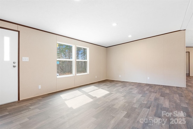 spare room featuring light wood-style floors, recessed lighting, and crown molding