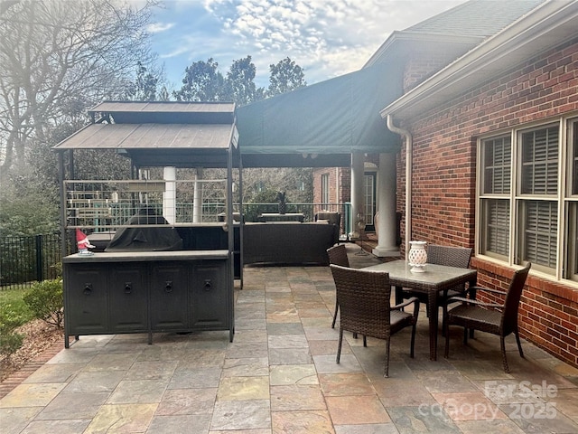 view of patio featuring an outdoor hangout area, fence, and outdoor dining area