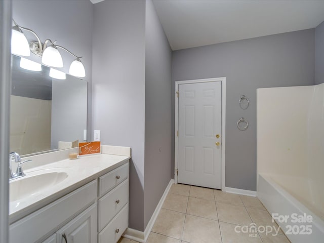 full bath with tile patterned flooring, baseboards, and vanity