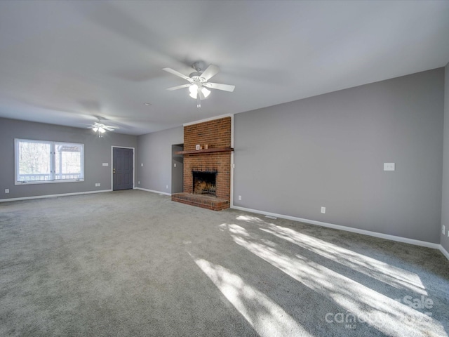 unfurnished living room with ceiling fan, a fireplace, baseboards, and carpet flooring