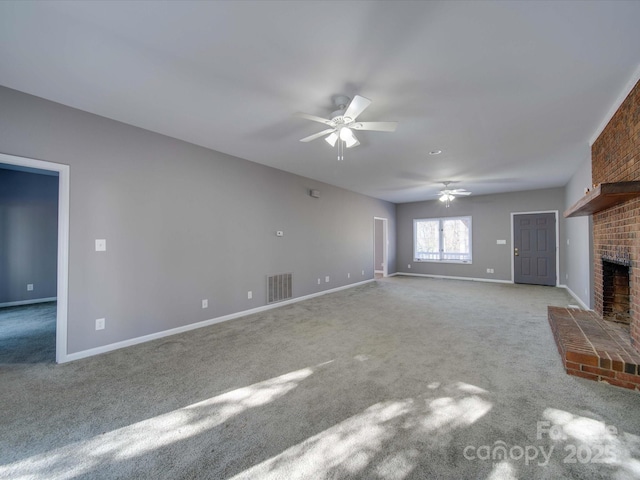 unfurnished living room featuring visible vents, baseboards, ceiling fan, carpet flooring, and a brick fireplace