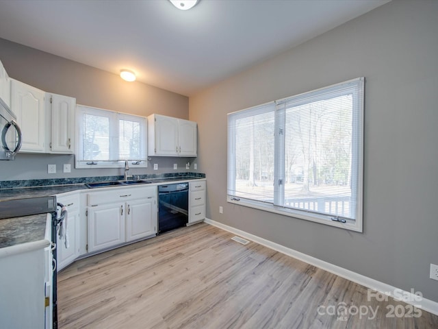 kitchen with range with electric cooktop, baseboards, dishwasher, white cabinetry, and a sink