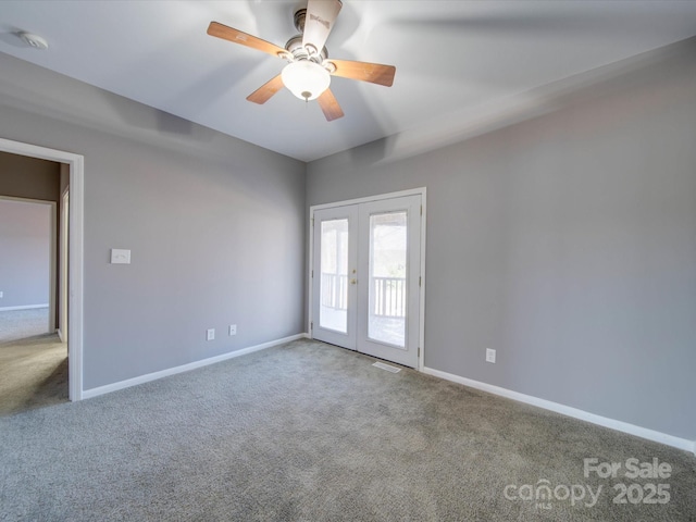 carpeted empty room with french doors, ceiling fan, and baseboards