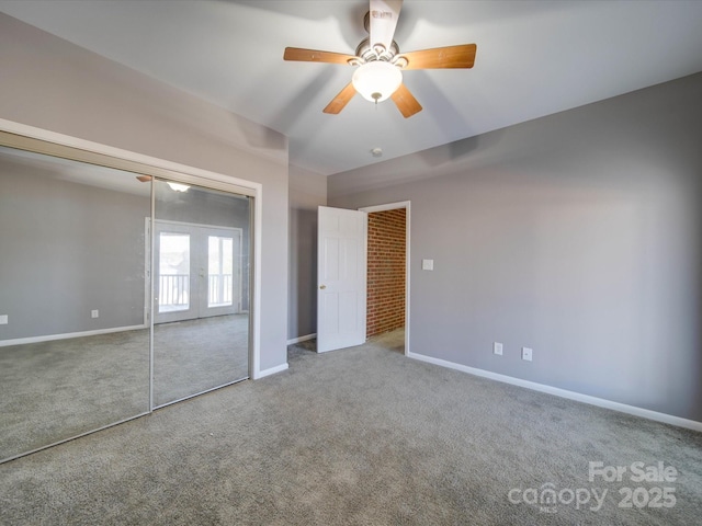 unfurnished bedroom featuring french doors, a closet, a ceiling fan, carpet flooring, and baseboards