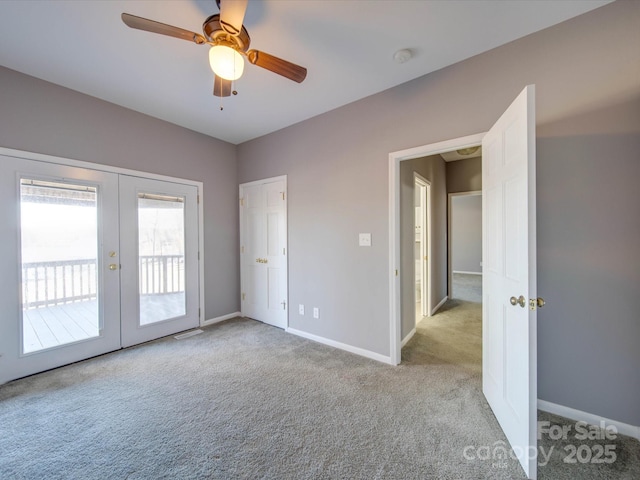 unfurnished room featuring carpet, baseboards, ceiling fan, and french doors