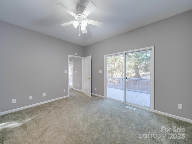 spare room with carpet, visible vents, ceiling fan, and baseboards