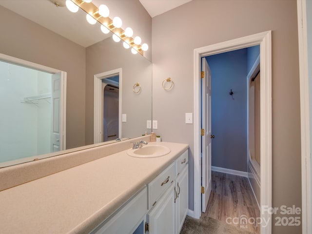 full bathroom with vanity and baseboards