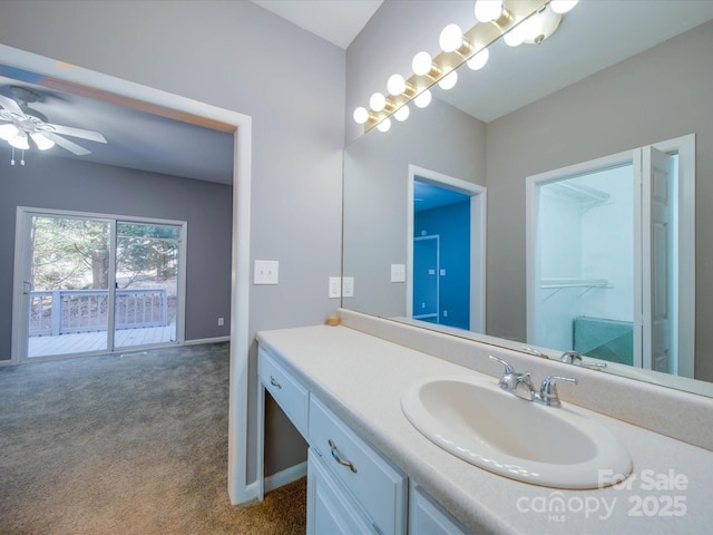 bathroom featuring ceiling fan, baseboards, and vanity