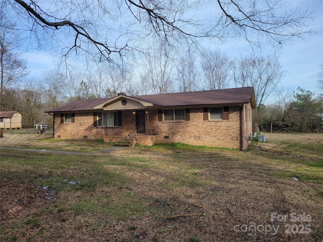 view of front of home with brick siding, crawl space, and a front lawn