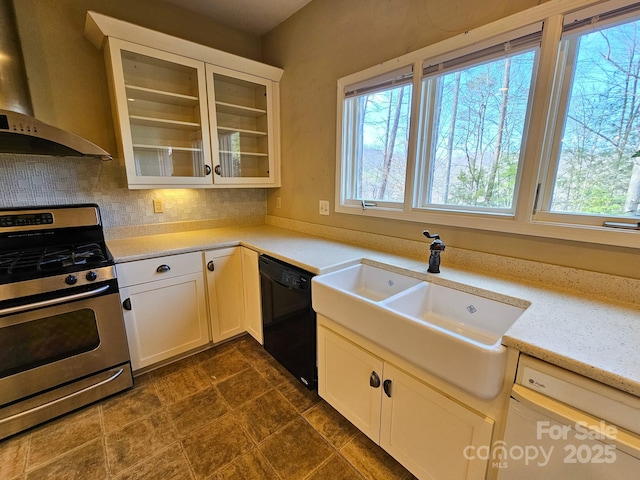 kitchen featuring black dishwasher, white cabinets, glass insert cabinets, wall chimney range hood, and stainless steel range with gas cooktop