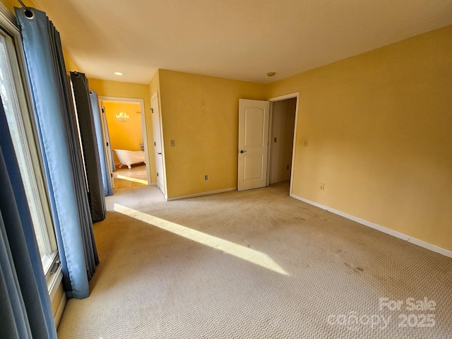 unfurnished bedroom featuring carpet and baseboards