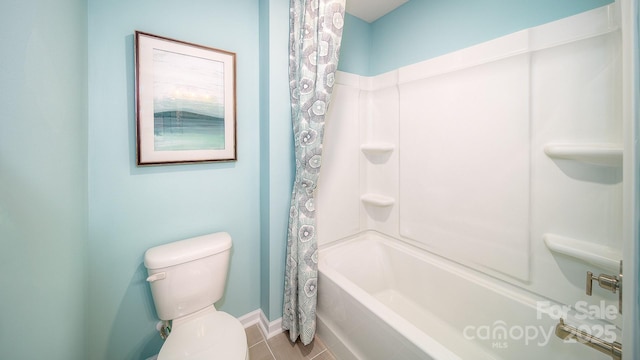 bathroom with baseboards, shower / tub combo, toilet, and tile patterned floors