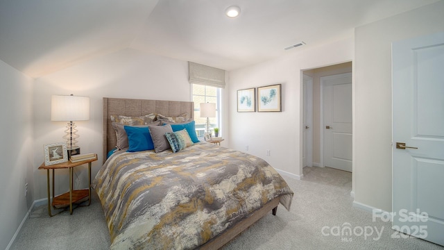 bedroom with vaulted ceiling, baseboards, visible vents, and light colored carpet