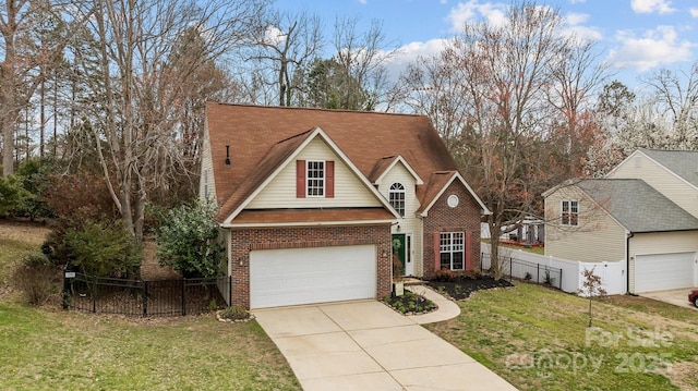 traditional home featuring a front lawn, fence, concrete driveway, a garage, and brick siding