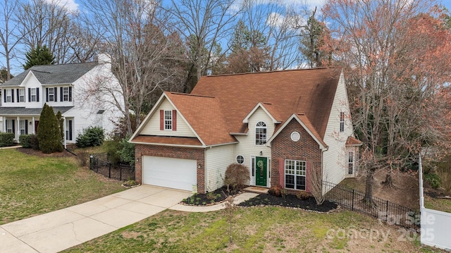 view of front facade featuring brick siding, a garage, a front yard, and fence