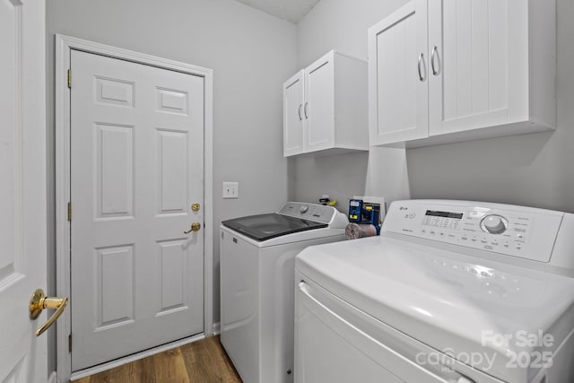 washroom featuring cabinet space, dark wood-style floors, and separate washer and dryer