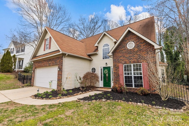 traditional-style house featuring concrete driveway, fence, brick siding, and a front yard