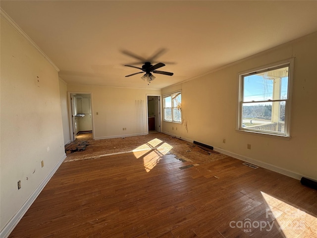 empty room with visible vents, ceiling fan, baseboards, ornamental molding, and hardwood / wood-style flooring