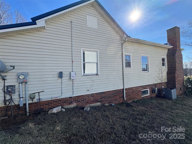 view of side of home featuring cooling unit