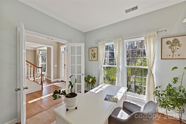 office with wood finished floors, visible vents, and baseboards