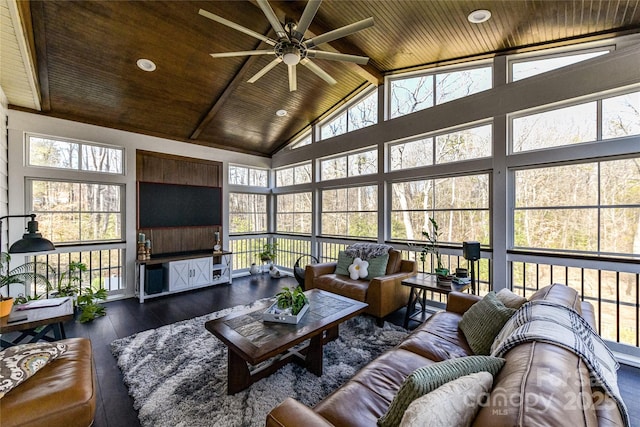 sunroom / solarium featuring lofted ceiling with beams, a ceiling fan, wood ceiling, and a healthy amount of sunlight