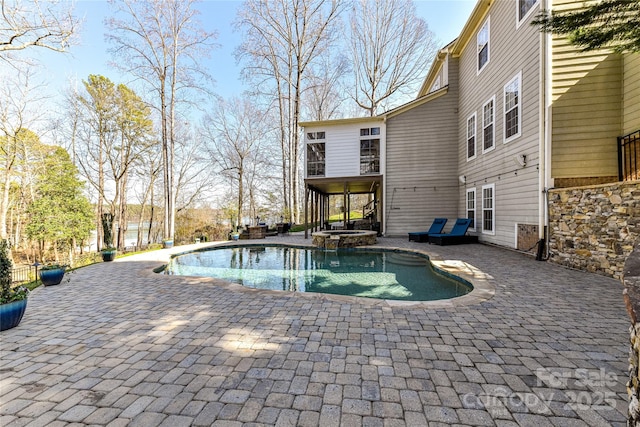 view of pool featuring a patio and a pool with connected hot tub