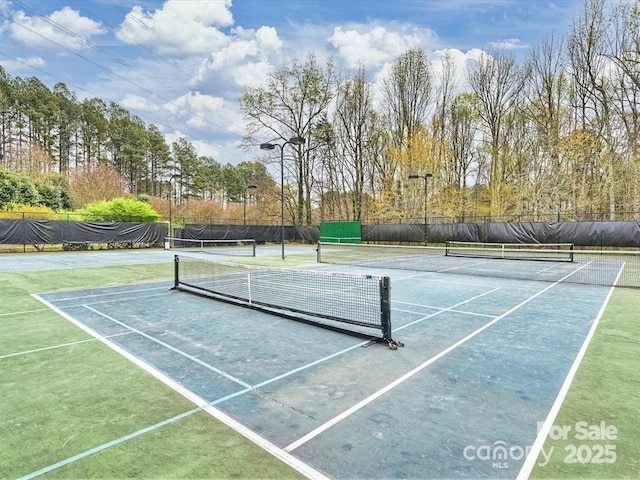 view of sport court featuring fence