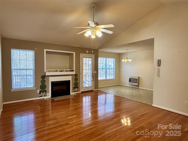 unfurnished living room featuring wood finished floors, a fireplace with flush hearth, and heating unit