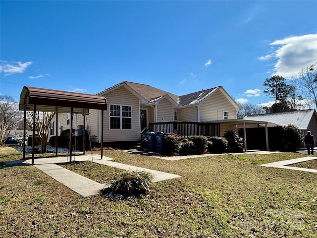 rear view of house featuring a carport and a yard