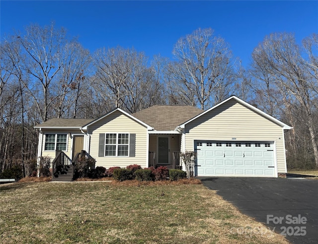 single story home with a front yard, driveway, and an attached garage