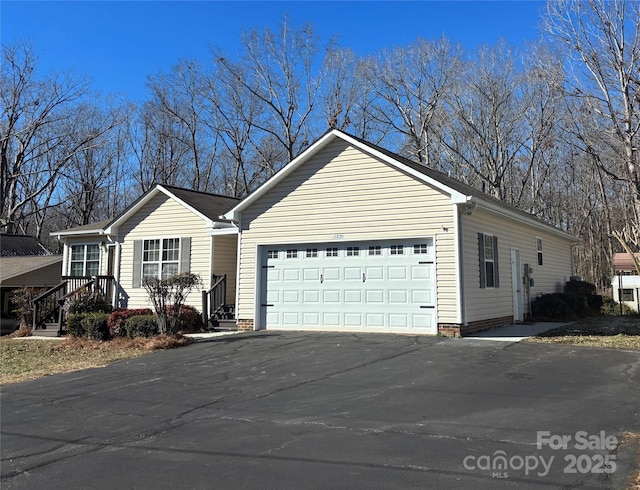 view of home's exterior with an attached garage and aphalt driveway