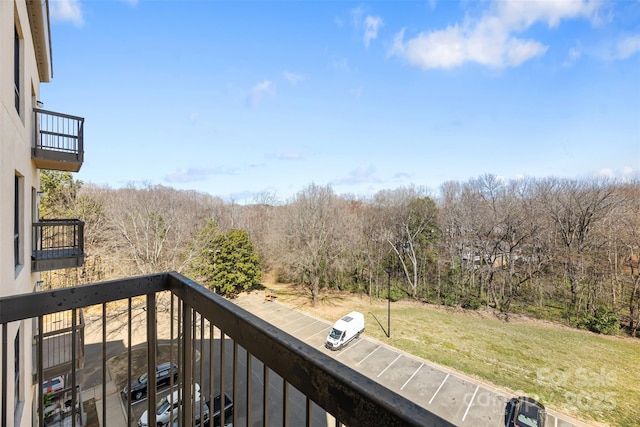 balcony featuring a forest view