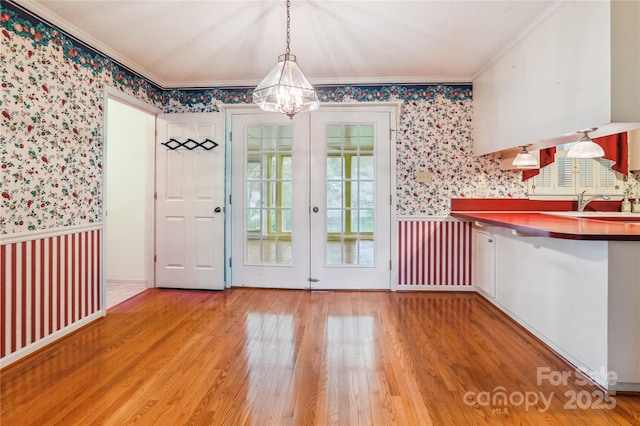 1007 Wentworth Dr, Kannapolis, NC 28081 - unfurnished dining area featuring ornamental molding, a wainscoted wall, a notable chandelier, and wallpapered walls