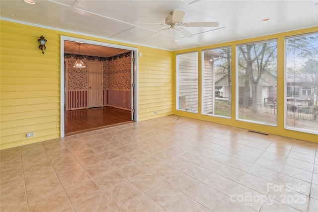 1007 Wentworth Dr, Kannapolis, NC 28081 - empty room featuring visible vents, light tile patterned flooring, and ceiling fan with notable chandelier