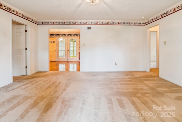 1007 Wentworth Dr, Kannapolis, NC 28081 - unfurnished room featuring french doors, carpet, and a textured ceiling
