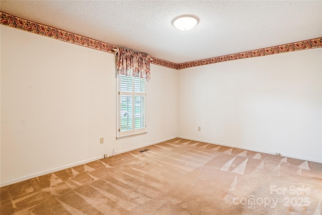1007 Wentworth Dr, Kannapolis, NC 28081 - carpeted empty room featuring a textured ceiling, baseboards, and visible vents
