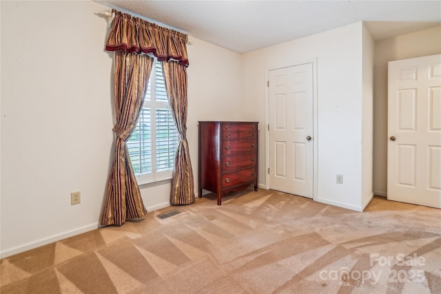 1007 Wentworth Dr, Kannapolis, NC 28081 - unfurnished bedroom featuring carpet, visible vents, and baseboards