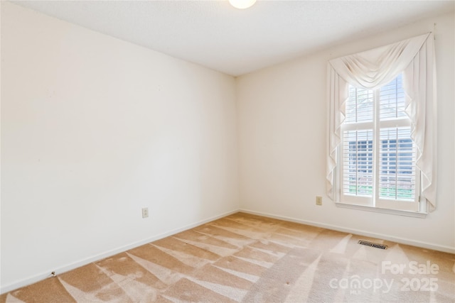 1007 Wentworth Dr, Kannapolis, NC 28081 - empty room featuring carpet flooring, baseboards, visible vents, and a wealth of natural light