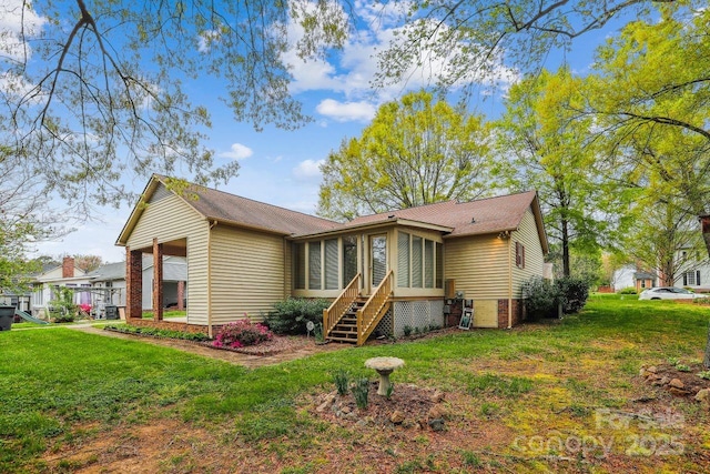 1007 Wentworth Dr, Kannapolis, NC 28081 - back of property with a sunroom and a lawn