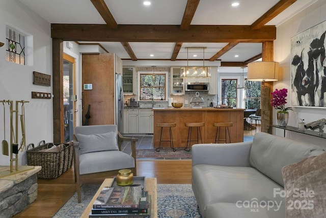 living room with beam ceiling, dark wood-type flooring, and recessed lighting