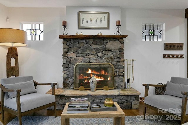 sitting room featuring a fireplace and wood finished floors