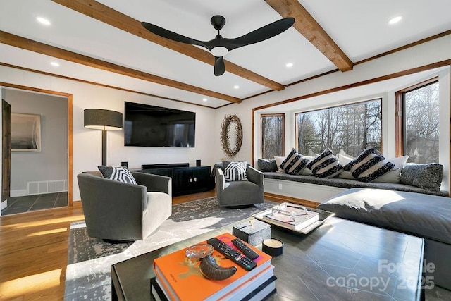 living area with visible vents, a ceiling fan, beamed ceiling, wood finished floors, and recessed lighting