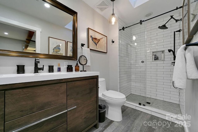 full bathroom with toilet, a shower stall, visible vents, and vanity