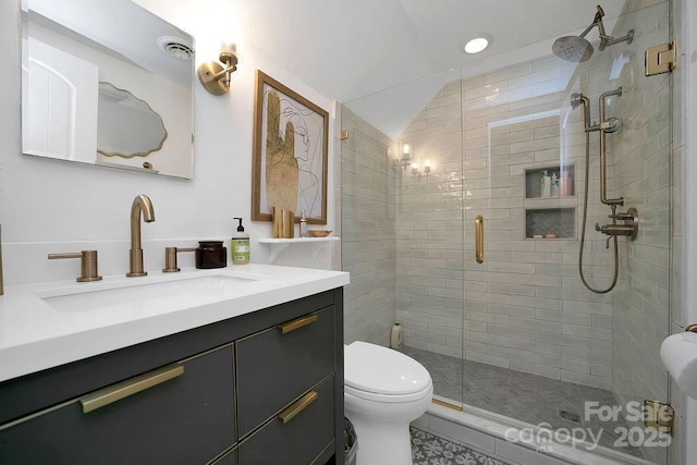 bathroom featuring a stall shower, visible vents, toilet, lofted ceiling, and vanity