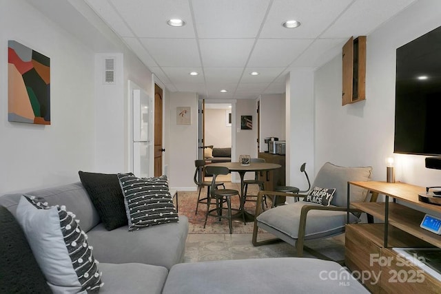 living room featuring visible vents, a paneled ceiling, and recessed lighting