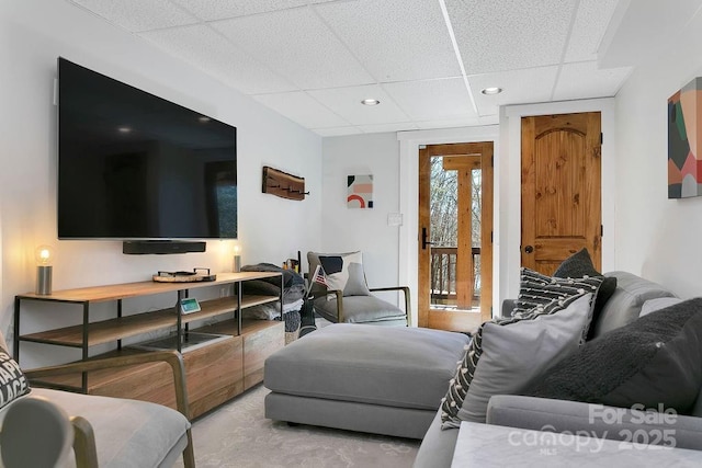 living room with a paneled ceiling, light carpet, and recessed lighting