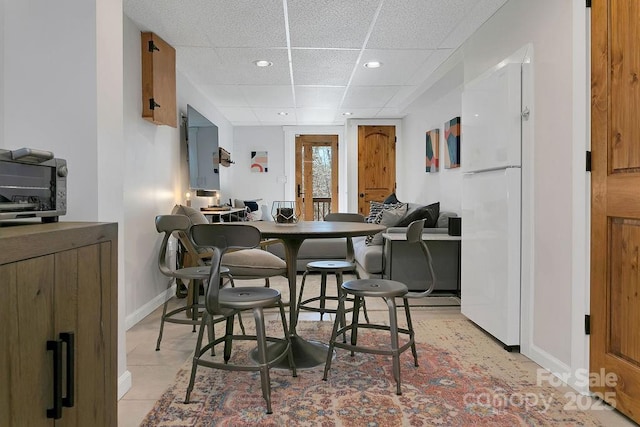 interior space with recessed lighting, a drop ceiling, and baseboards